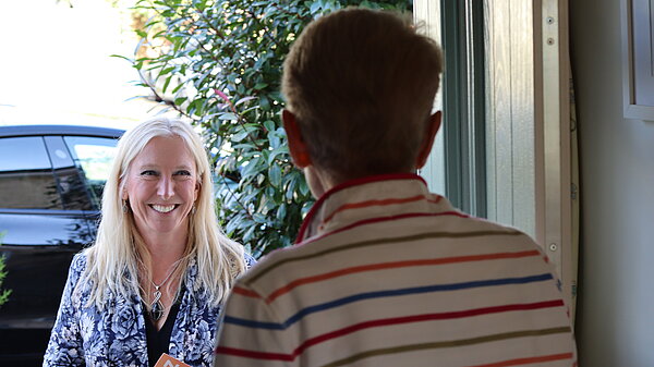 Roz Savage talking to a resident at the door