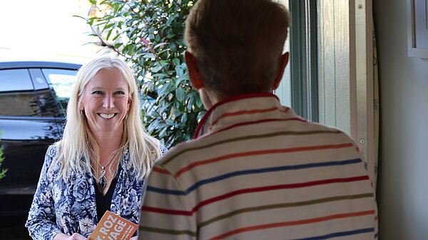 Roz Savage talking to a resident at the door